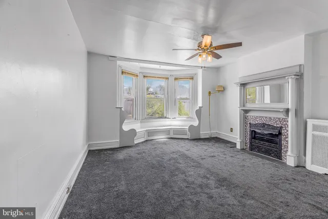 wooden floor in an empty room with a fireplace