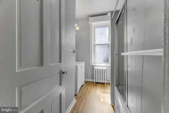 a view of a hallway with wooden floor and staircase