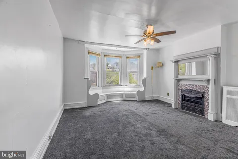 wooden floor in an empty room with a fireplace