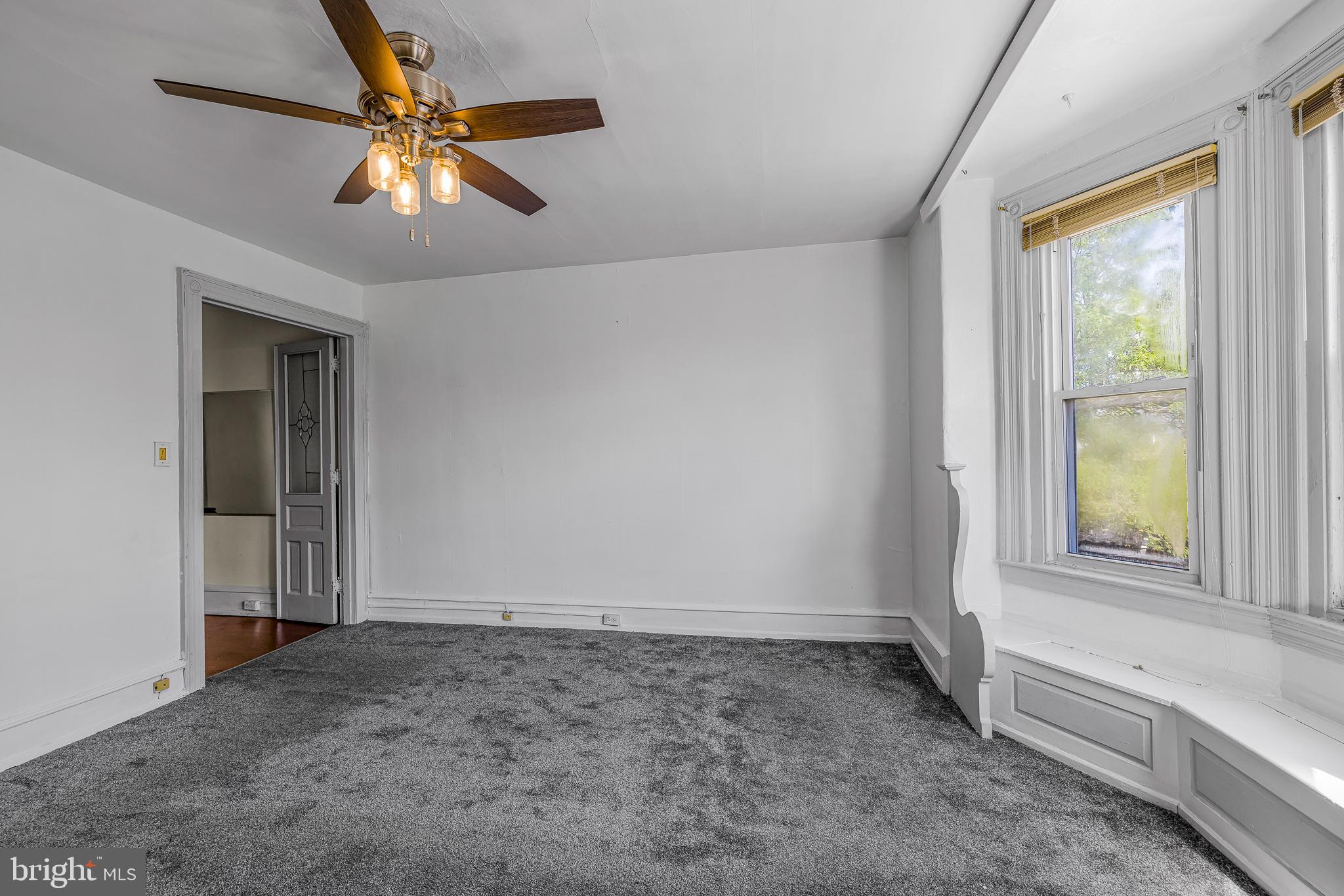 526 North 58th Street Philadelphia, PA 19131 - Photo 16 of 23 an empty room with a window and a chandelier fan