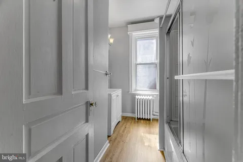a view of a hallway with wooden floor and staircase