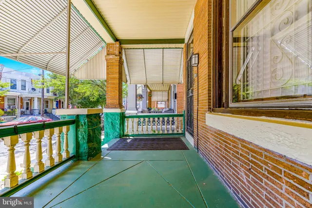 a view of a house with a porch and furniture
