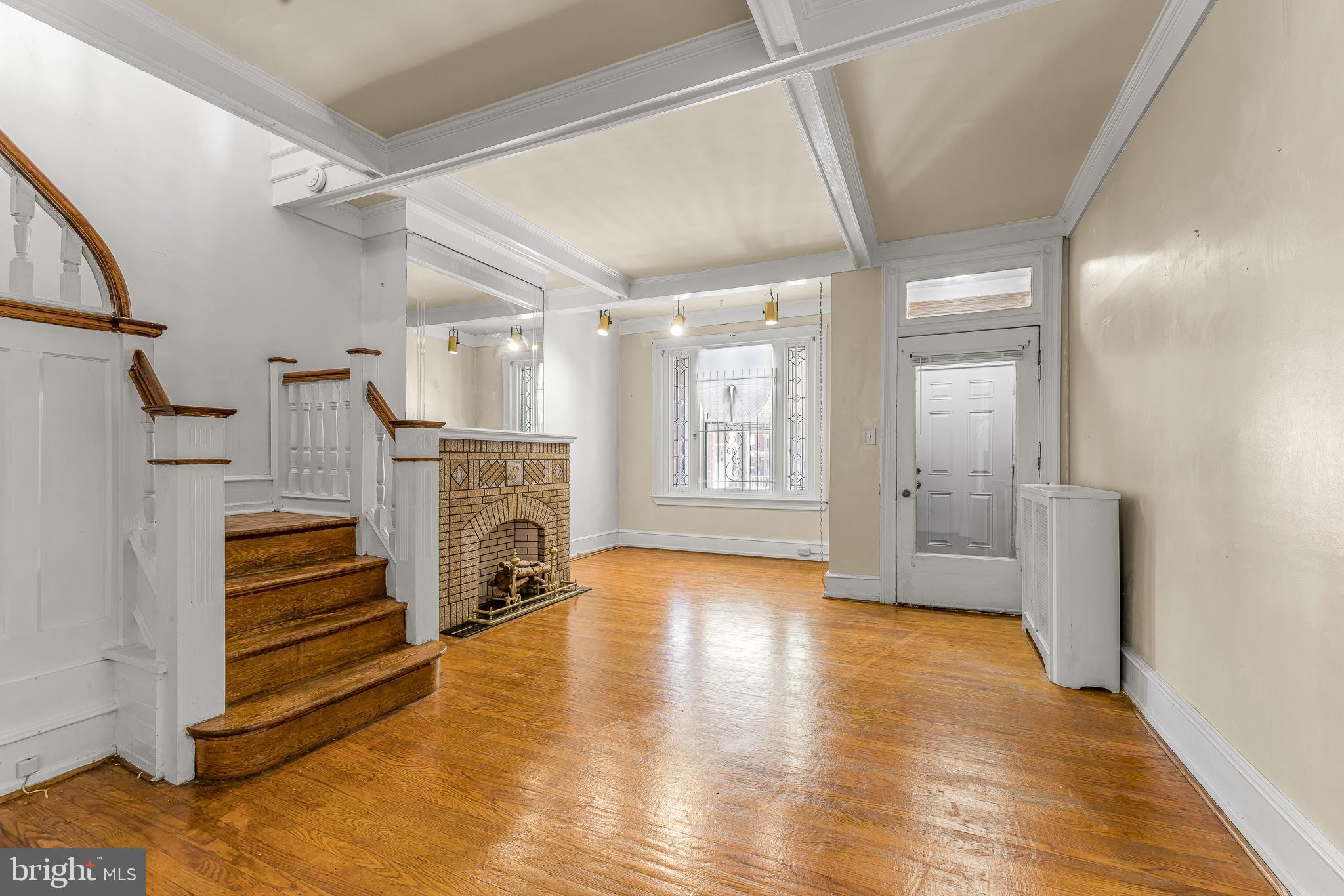 526 North 58th Street Philadelphia, PA 19131 - Photo 6 of 23 a view of a livingroom with a fireplace a ceiling fan and wooden floor