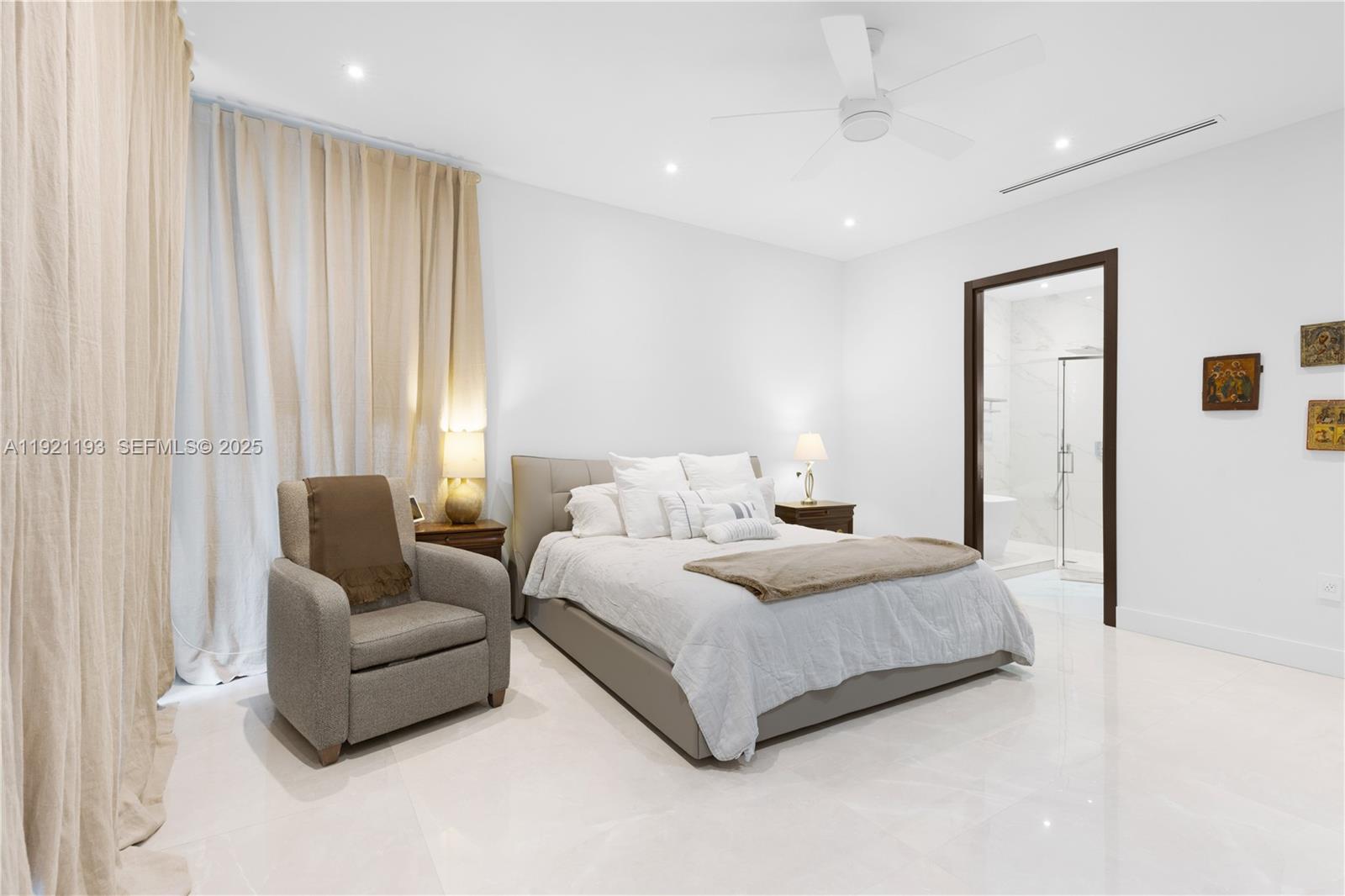 2420 Southwest 24th Street Miami, FL 33145 - Photo 34 of 53 a spacious bedroom with a bed and a couch