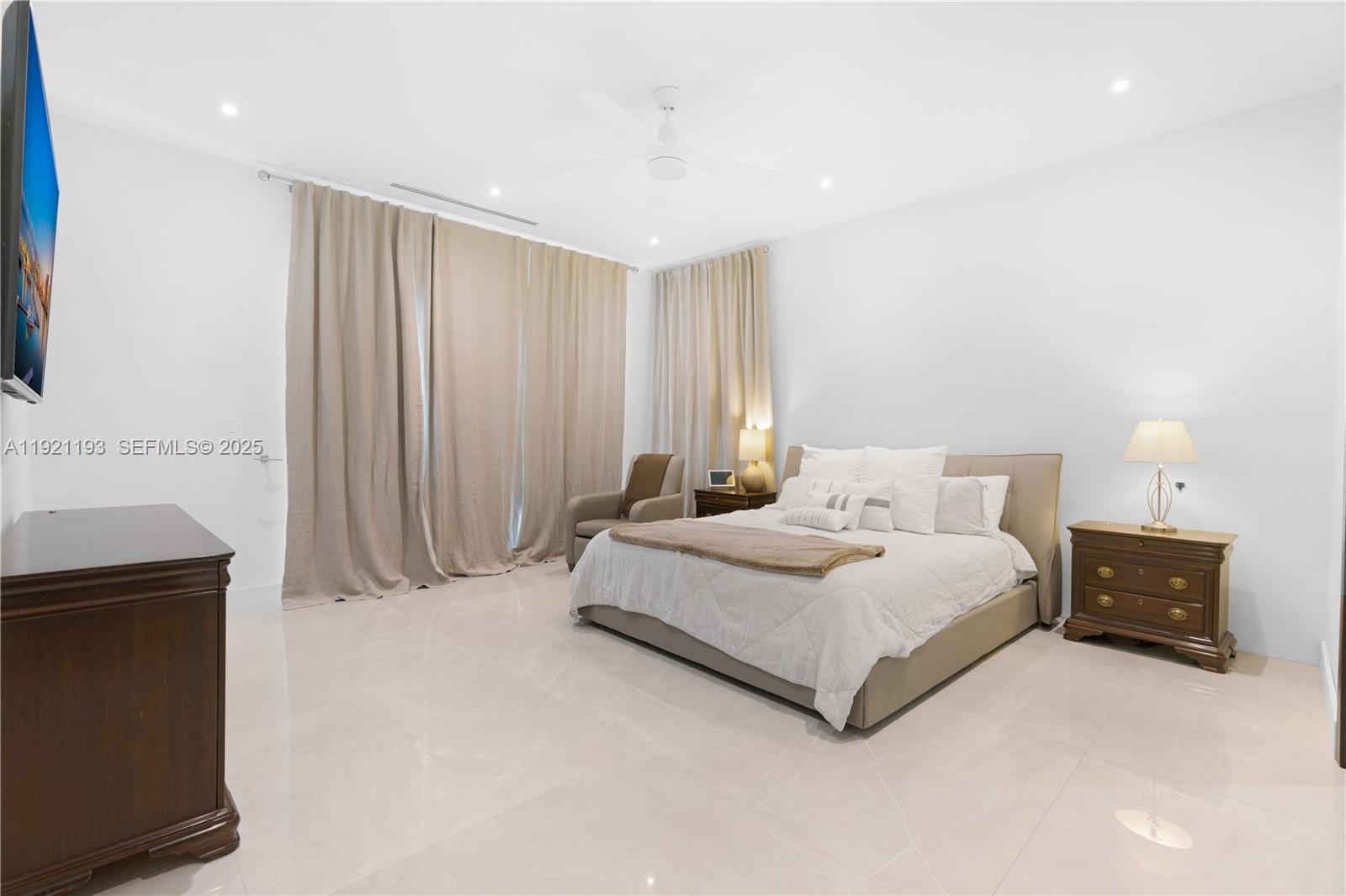 2420 Southwest 24th Street Miami, FL 33145 - Photo 35 of 53 a spacious bedroom with a bed and a lamp