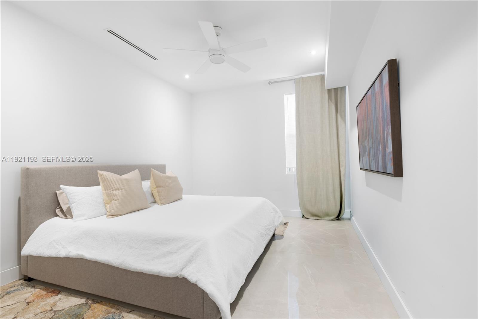 2420 Southwest 24th Street Miami, FL 33145 - Photo 45 of 53 a bedroom with a bed and a night stand