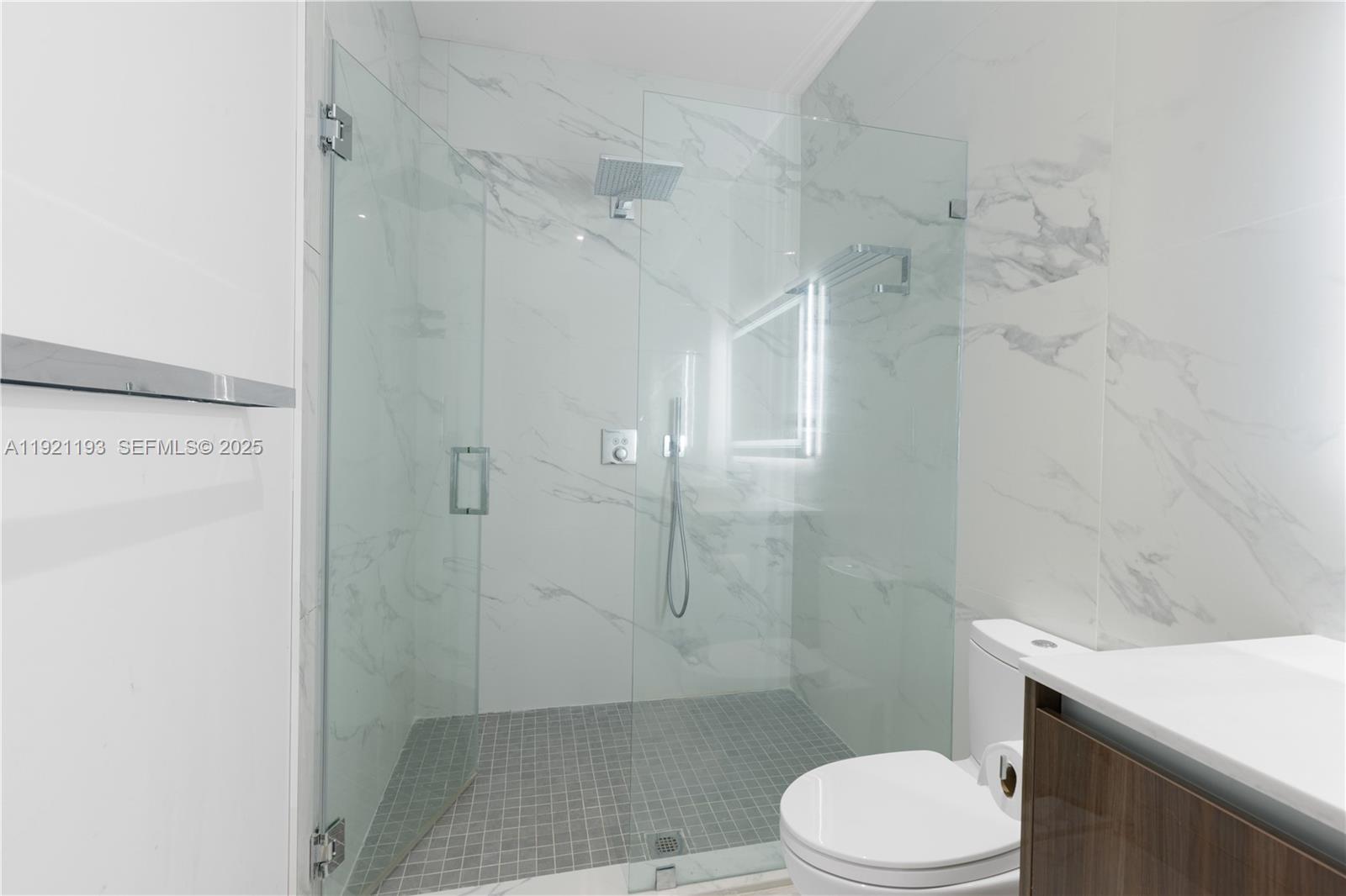 2420 Southwest 24th Street Miami, FL 33145 - Photo 46 of 53 a bathroom with a toilet a sink and shower