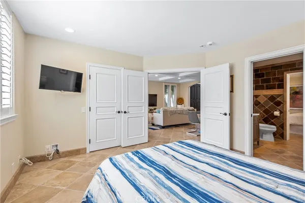 a bedroom with a bed and a television