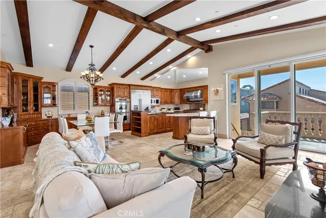 a living room with furniture and a view of kitchen