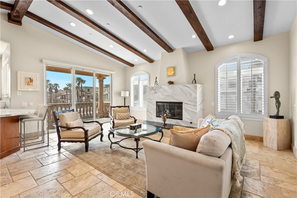 1000 Mandalay Beach Road Oxnard, CA 93035 - Photo 20 of 33 a living room with furniture a fireplace and a large window