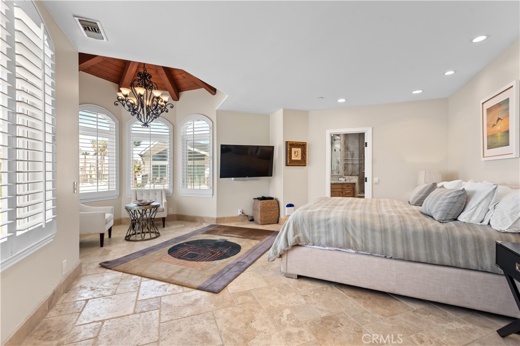 1000 Mandalay Beach Road Oxnard, CA 93035 - Photo 28 of 33 a bedroom with a bed a flat screen tv and a large window