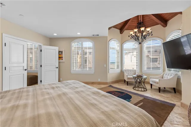 a bedroom with a bed and a chandelier