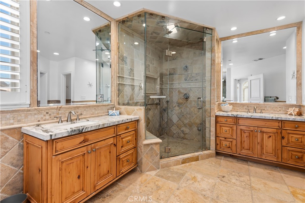 1000 Mandalay Beach Road Oxnard, CA 93035 - Photo 30 of 33 a bathroom with a granite countertop double vanity sink mirror shower and a bathtub