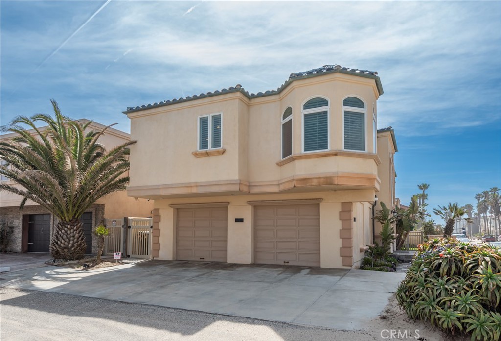 1000 Mandalay Beach Road Oxnard, CA 93035 - Photo 3 of 33 a front view of a house with a garden