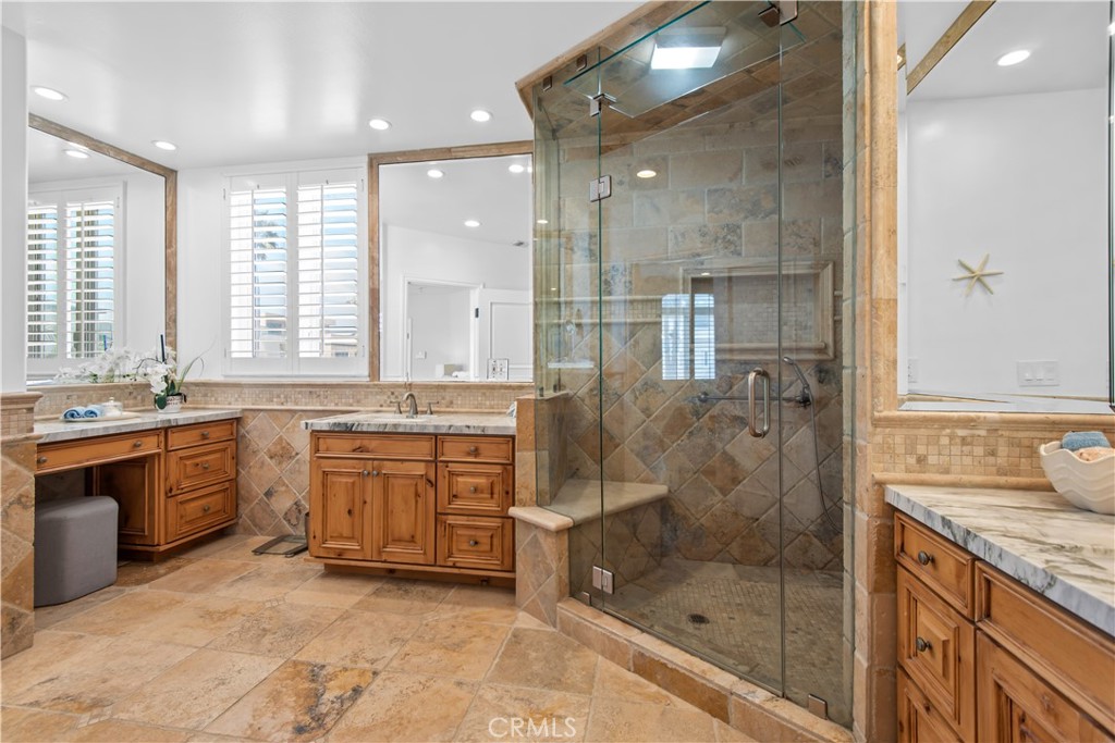 1000 Mandalay Beach Road Oxnard, CA 93035 - Photo 31 of 33 a bathroom with a granite countertop tub sink shower and mirror