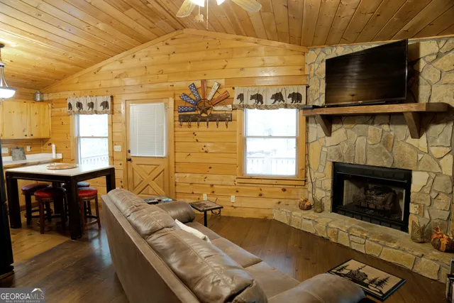 a living room with furniture flat screen tv and a fireplace