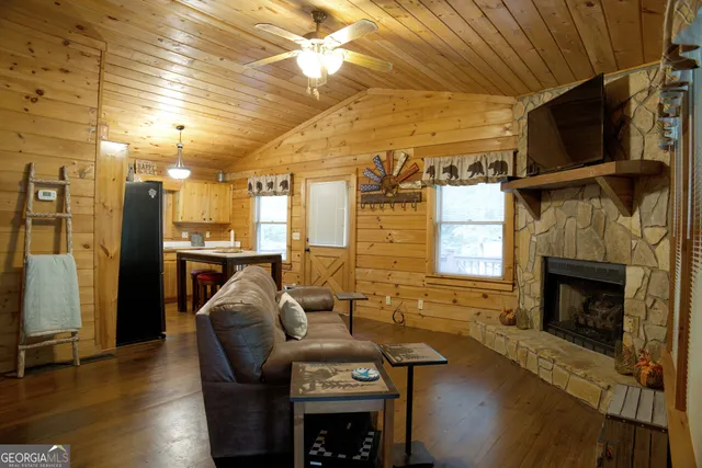a living room with fireplace furniture and a flat screen tv
