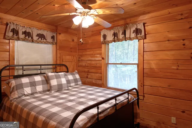 a bedroom with a bed and a mirror