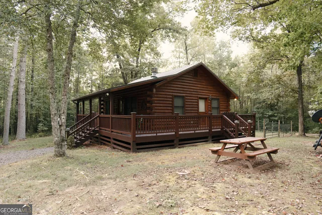 a backyard of a house with wooden fence and trees