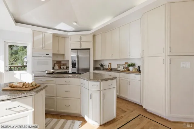 a kitchen with white cabinets and appliances
