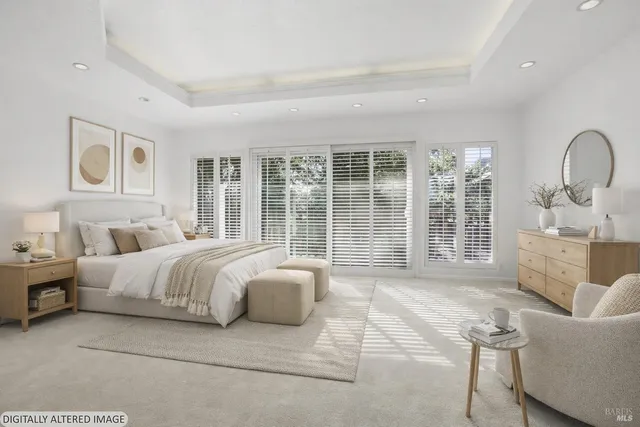 a spacious bedroom with a bed and a large window