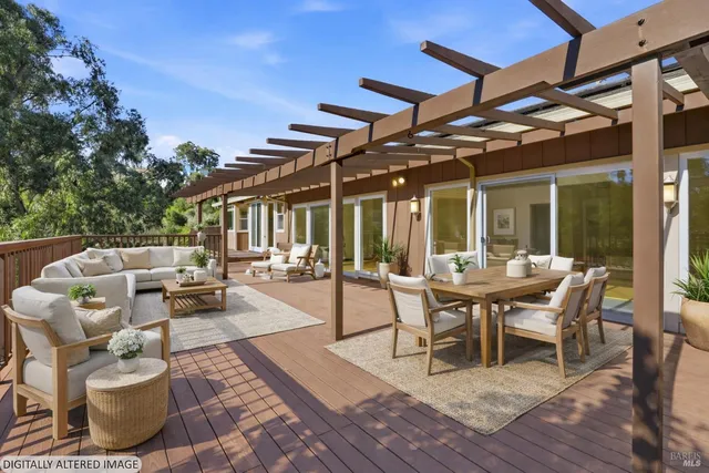 a view of a patio with dining table and chairs with wooden floor