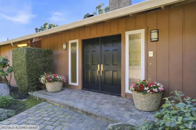 a room with a wooden bench and potted plants