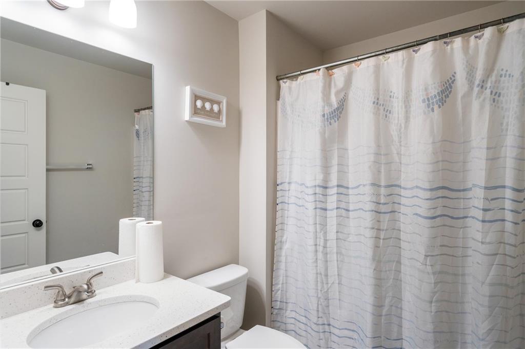 712 Fleeting Way Monroe, GA 30655 - Photo 25 of 29 a bathroom with a sink and a mirror