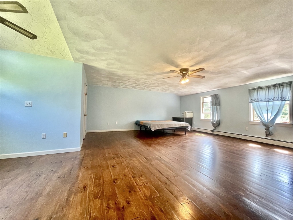 43 Tower Hill Road Brimfield, MA 01010 - Photo 26 of 36 a view of a livingroom with wooden floor and a ceiling fan