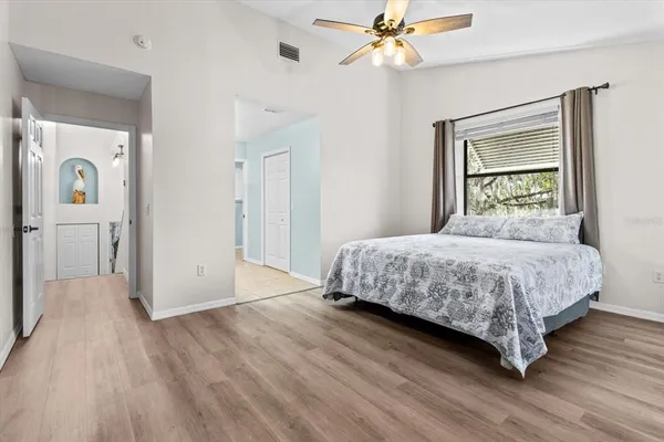a bedroom with a bed and a chandelier