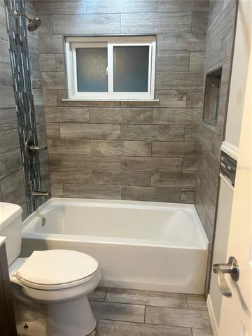 a bathroom with a toilet and a bathtub