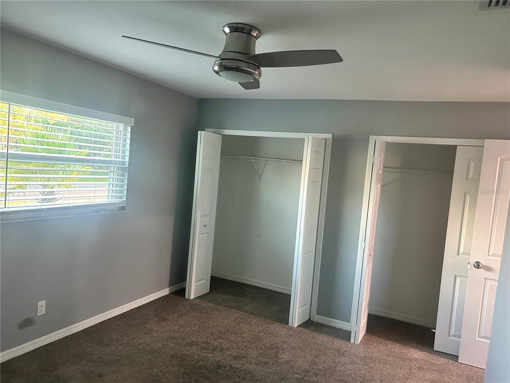 501 Firefly Lane Apollo Beach, FL 33572 - Photo 8 of 17 an empty room with a ceiling fan and window
