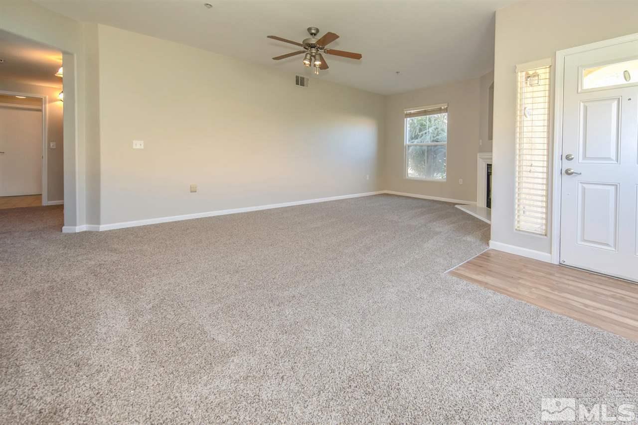 9050 Double R Boulevard, Unit 911 Reno, NV 89521 - Photo 4 of 22 an empty room with windows and fan