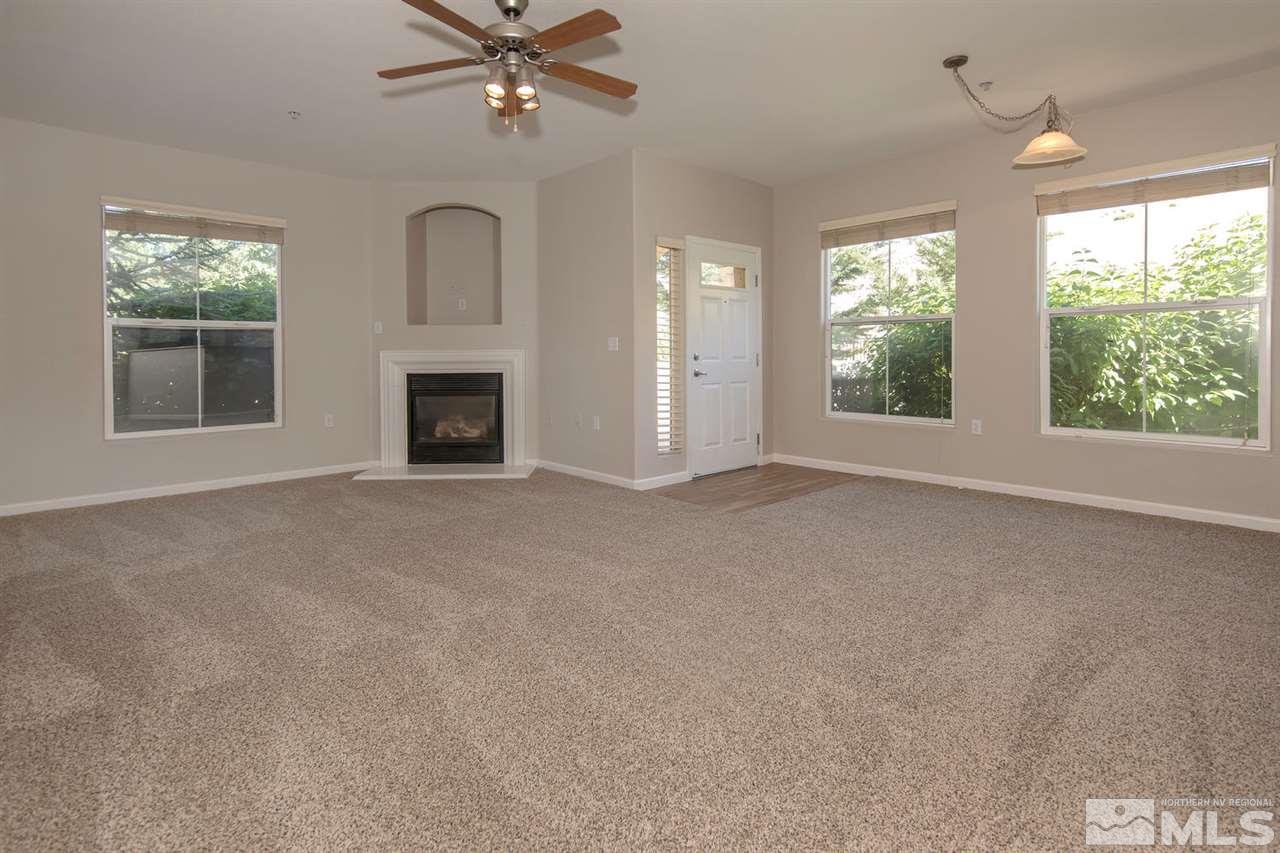 9050 Double R Boulevard, Unit 911 Reno, NV 89521 - Photo 5 of 22 an empty room with windows and fireplace