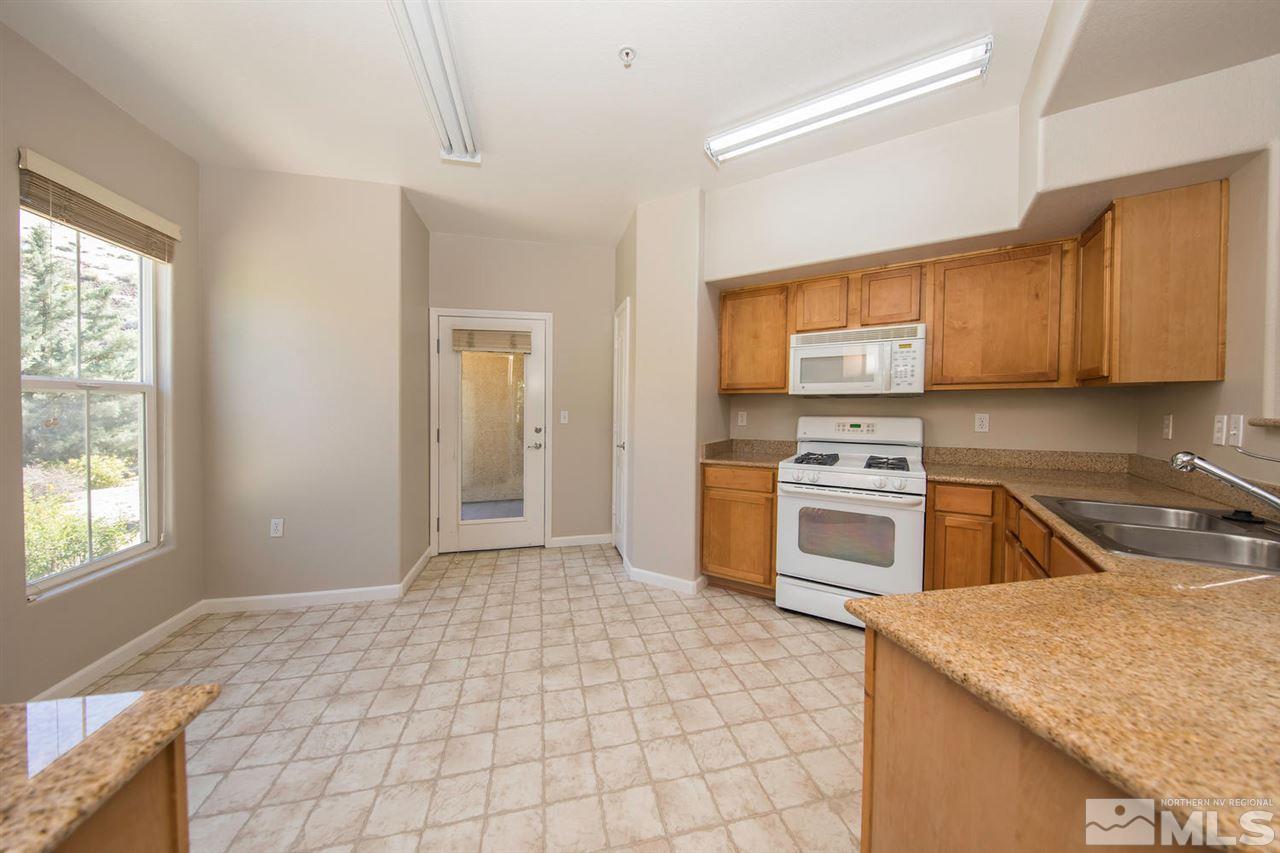9050 Double R Boulevard, Unit 911 Reno, NV 89521 - Photo 9 of 22 a kitchen with a stove a sink and a refrigerator