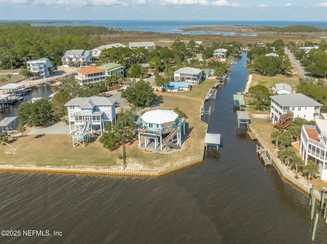 an aerial view of a house with a ocean view