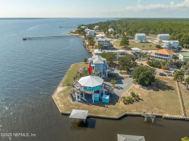 an aerial view of a house with a yard