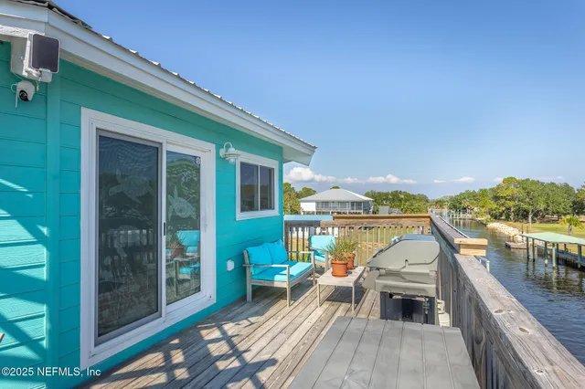 a view of a balcony with chairs and wooden floor