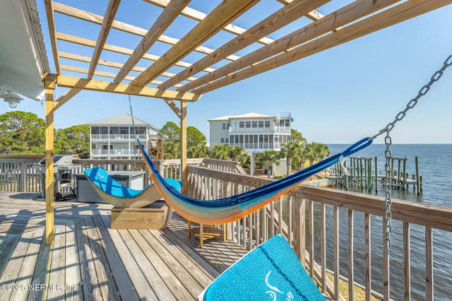 a view of balcony with a floor to ceiling window and wooden floor
