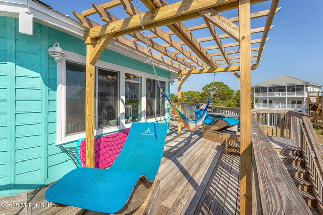 a dining room filled chandelier and wooden floor