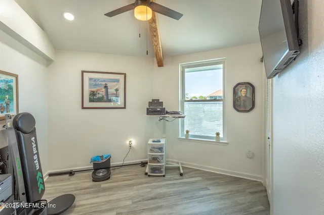 a bedroom with a bed table and a window