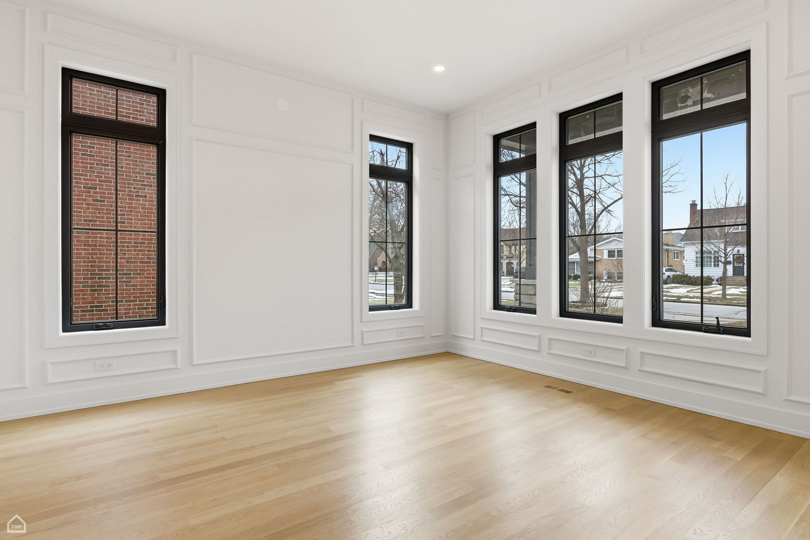 135 Elmore Street Park Ridge, IL 60068 - Photo 3 of 23 a view of an empty room with wooden floor and a window