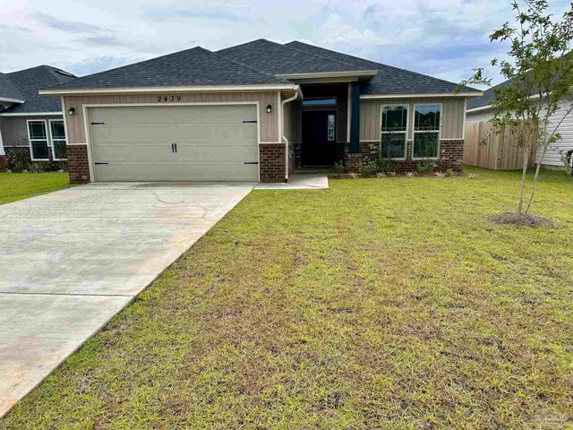 a view of a house with a yard and sitting area