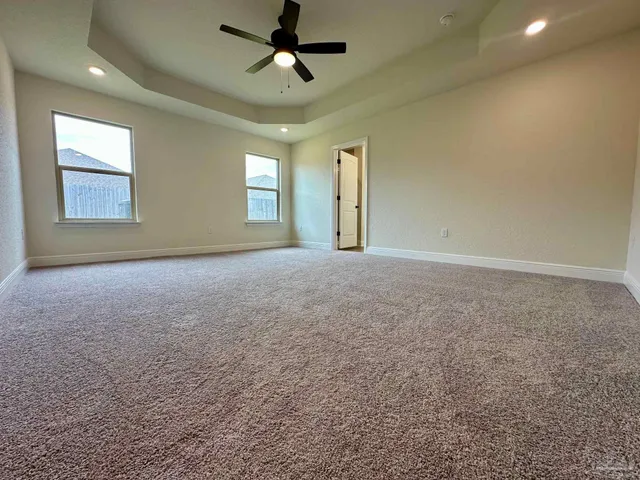 a view of a livingroom with a ceiling fan and window