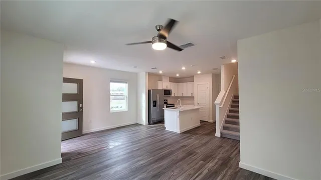 a view of a kitchen center island wooden floor and a window