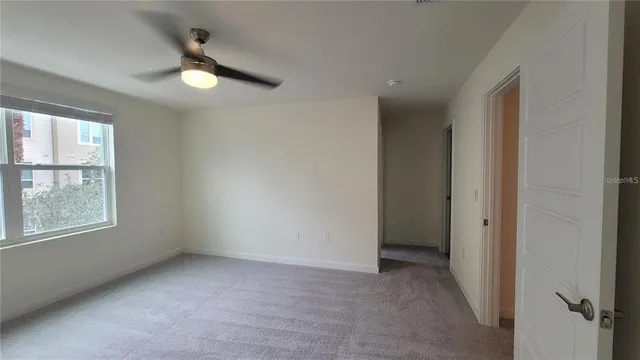 an empty room with windows and closet