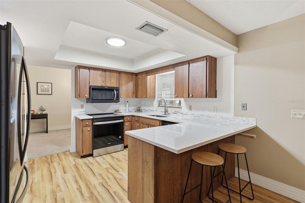 244 Angeles Road DeBary, FL 32713 - Photo 15 of 41 a kitchen with stainless steel appliances granite countertop a stove refrigerator sink and cabinets