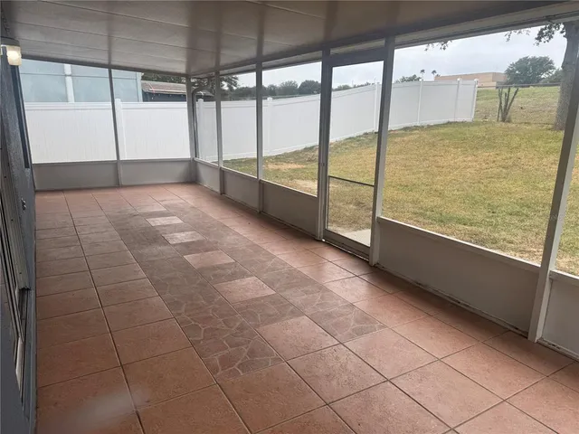 a view of an empty room with a floor to ceiling window