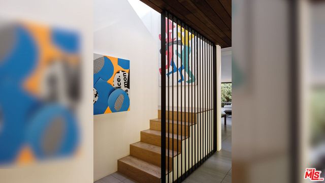 a view of a hallway with a door and stairs