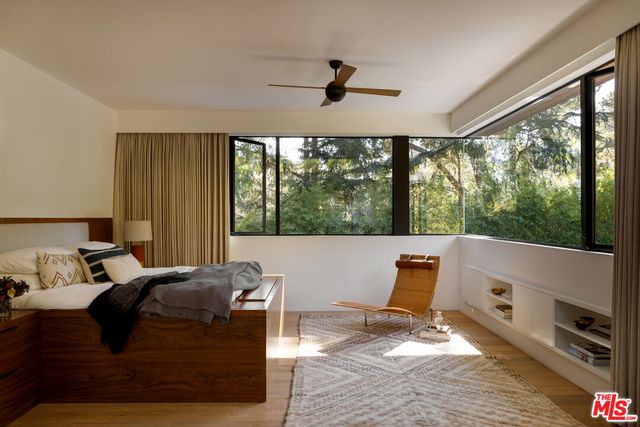 a living room with furniture and a floor to ceiling window
